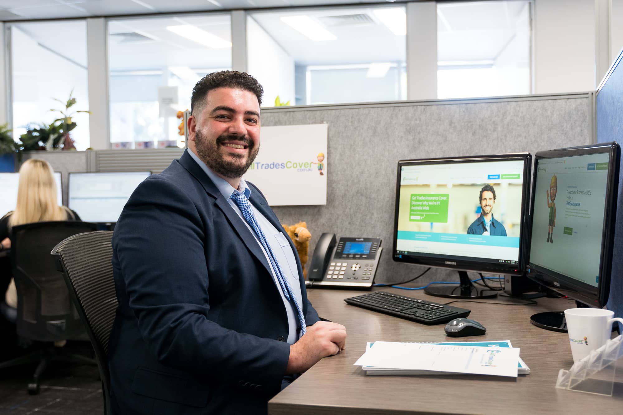 Owner of All Trades Cover Trade insurance expert sitting at a desk