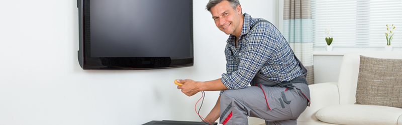 Technician Installing TV Set Top Box At Home Home Theatre and AV Installers Public Liability Insurance