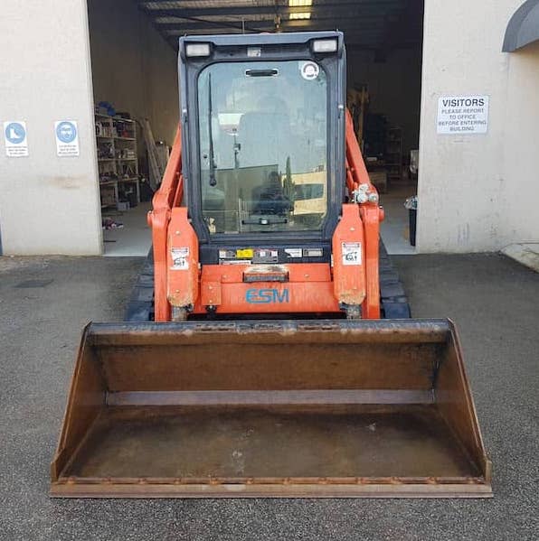 A bobcat skid steer; ready for deployment but covered by insurance in case of an incident.
