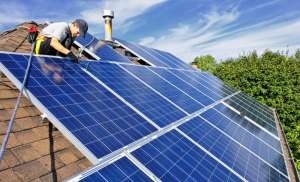 Roofer installing solar panels.