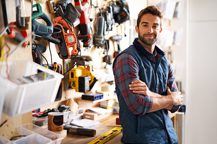 handyman-insurance-header Handyman standing in front of his tools