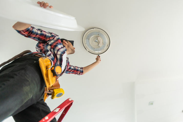 handyman-light Handyman fixing a light fixture