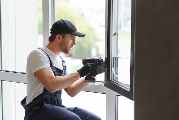 handyman-window Handyman drilling into a window