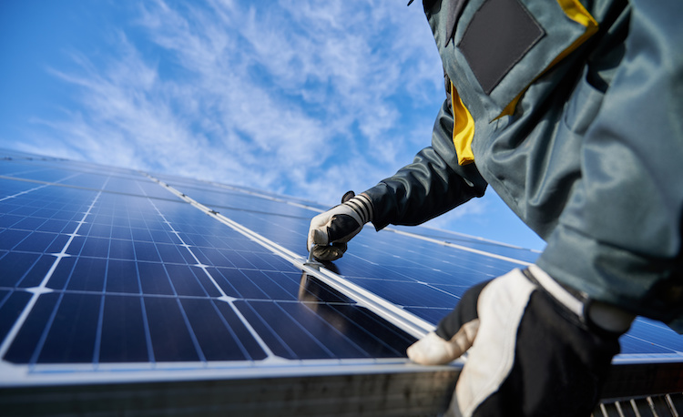 Solar installer aligning panels