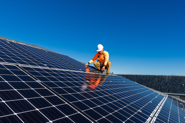 Solar panel installer on a roof
