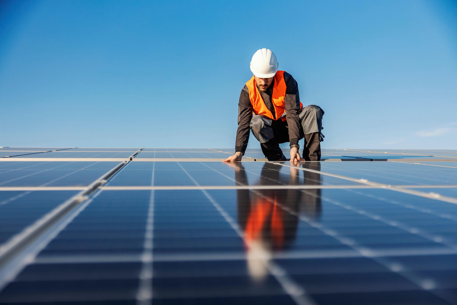 Solar panel installer installing solar panels