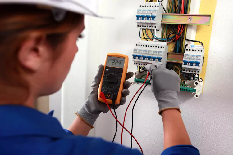 Insured electrician getting a reading from a fuse box