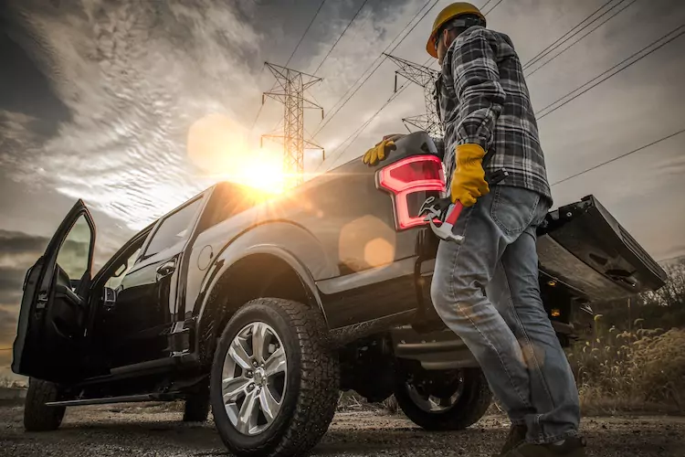 Insured roofer grabbing tools from his commercial vehicle