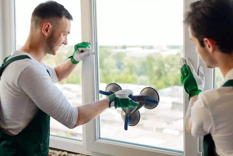 Insured glaziers fitting a window