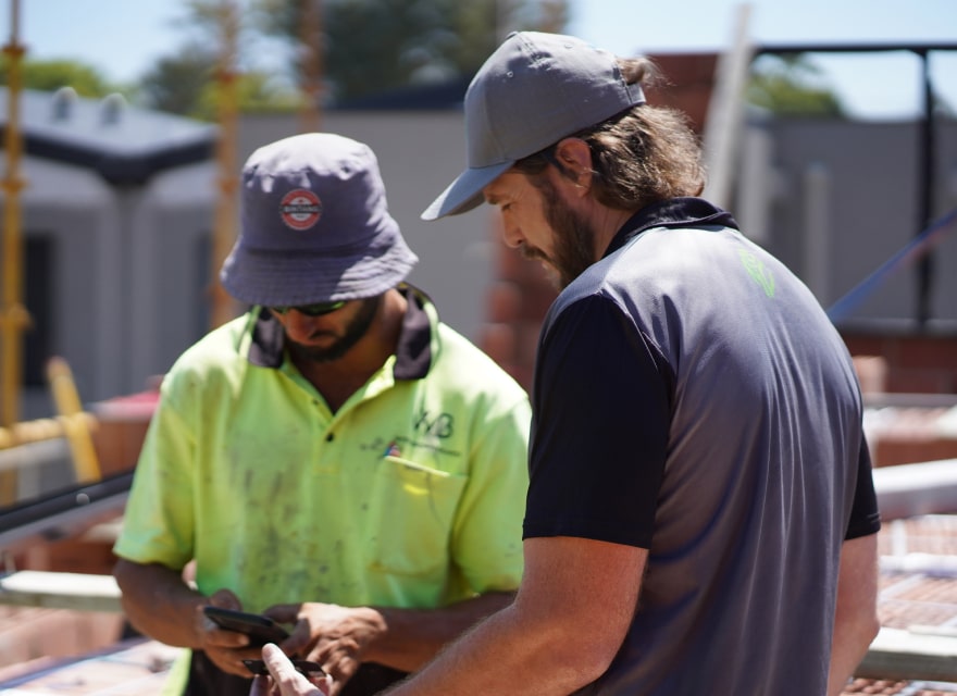John Elliott discussing builders insurance with a builder