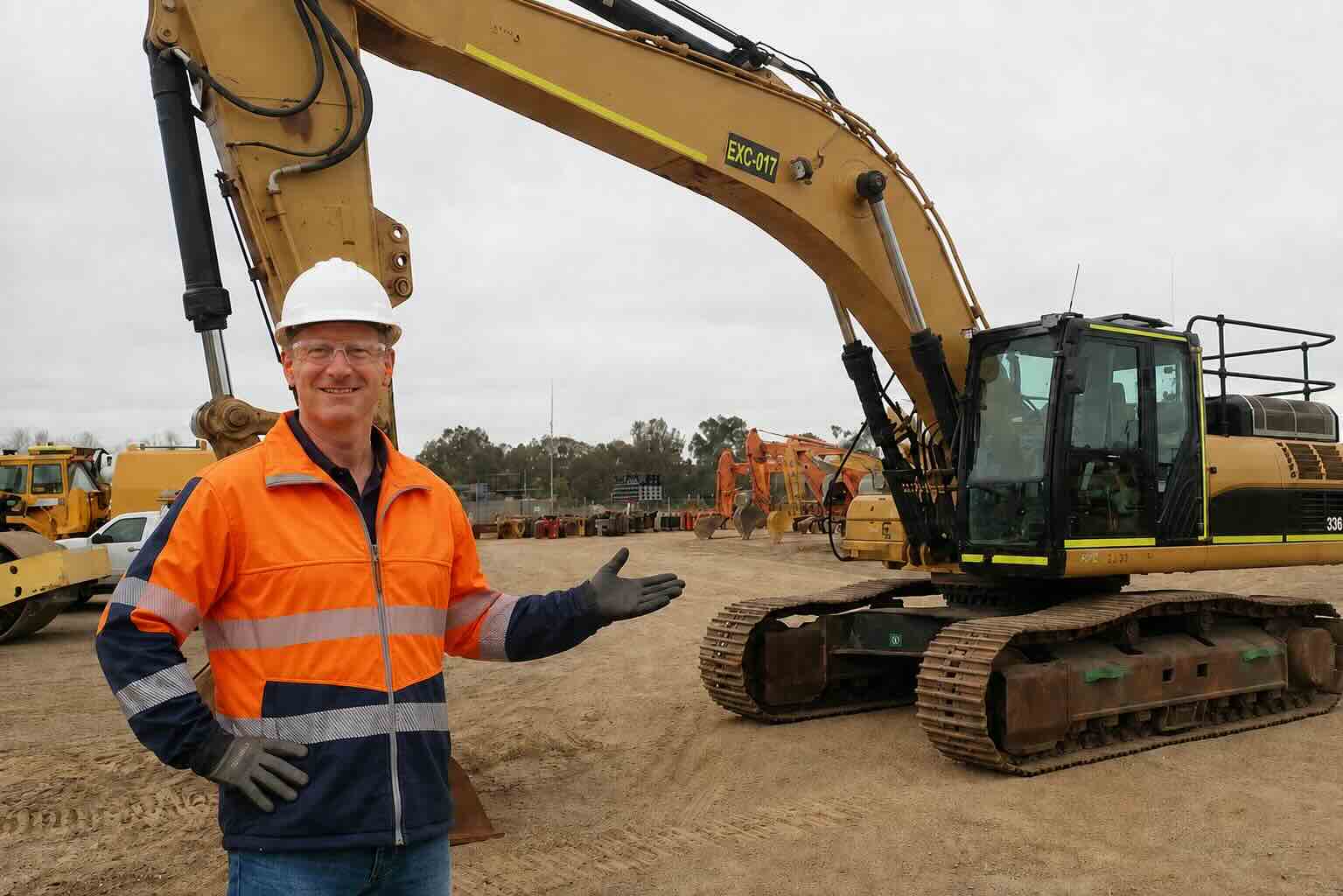 Insured excavator standing in front of a Caterpillar excavator