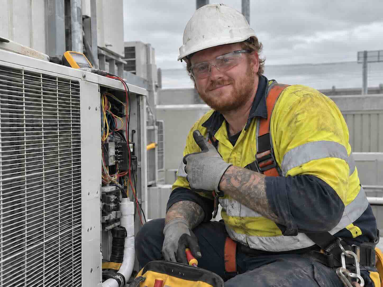 Insured HVAC contractor inspecting an AC unit
